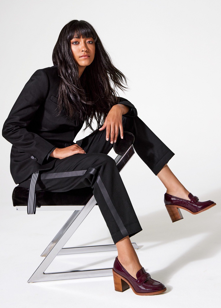 a woman sitting in a chair wearing Franco Sarto heeled loafers
