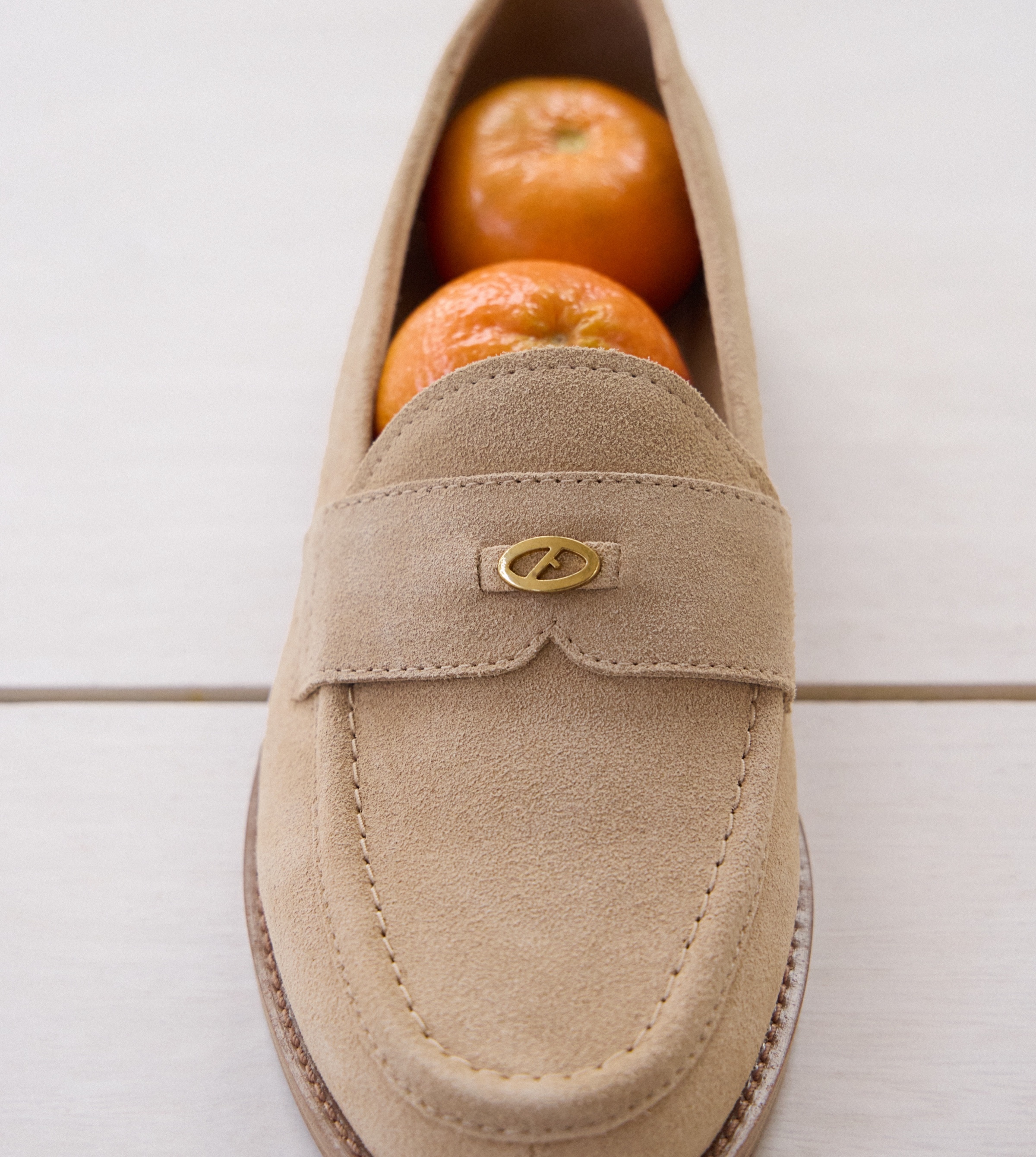 stellan loafer in beige with oranges sitting inside the shoe