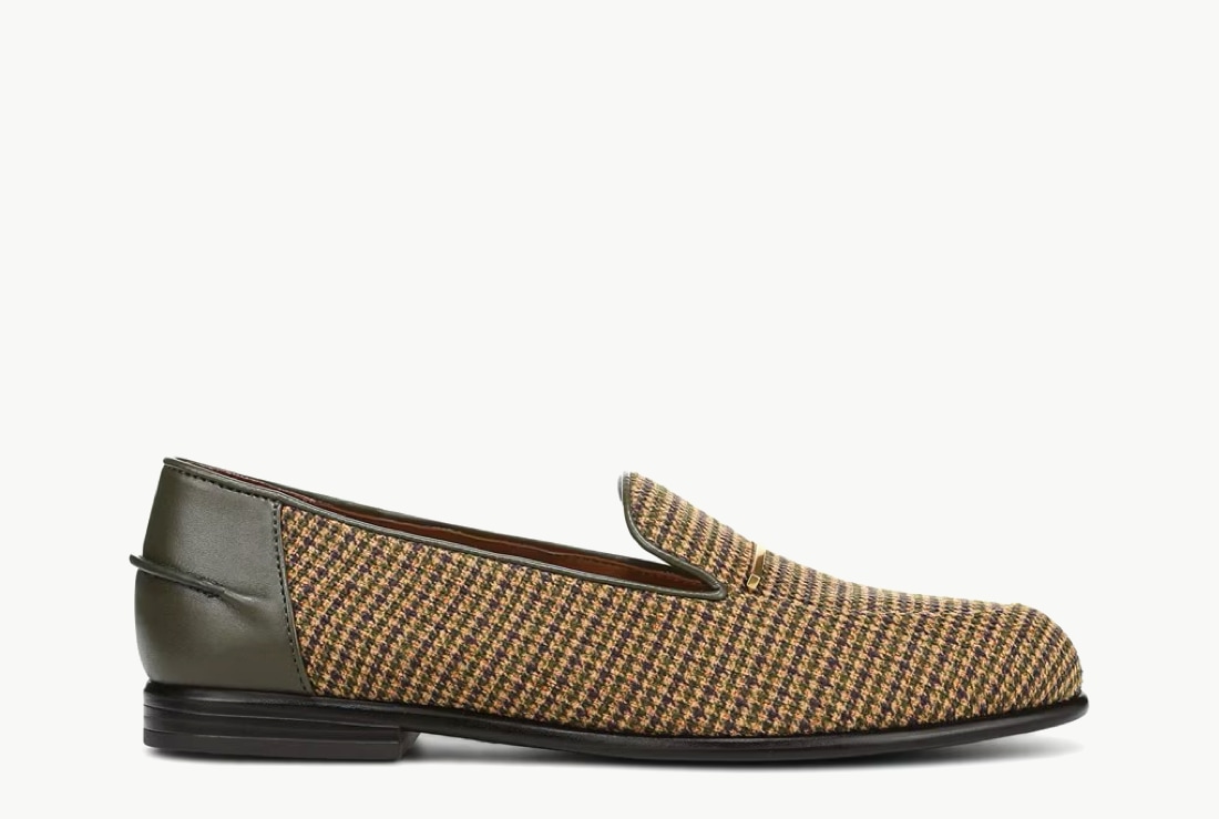 Side view of a women’s loafer in a yellow plaid fabric with a leather panel around the heel.  