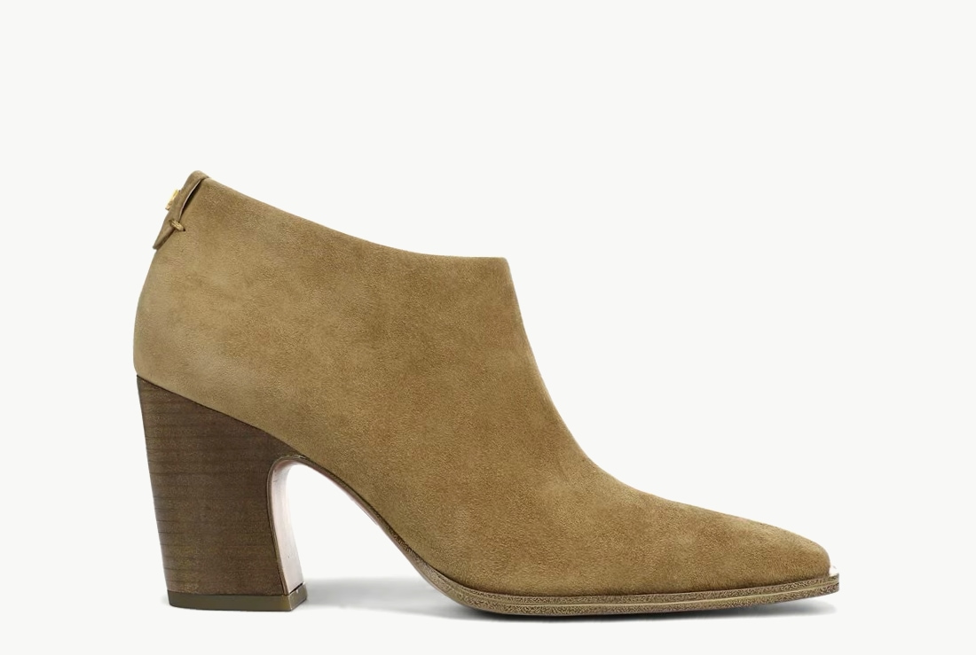 Side view of a women’s heeled bootie in moss green suede.  
